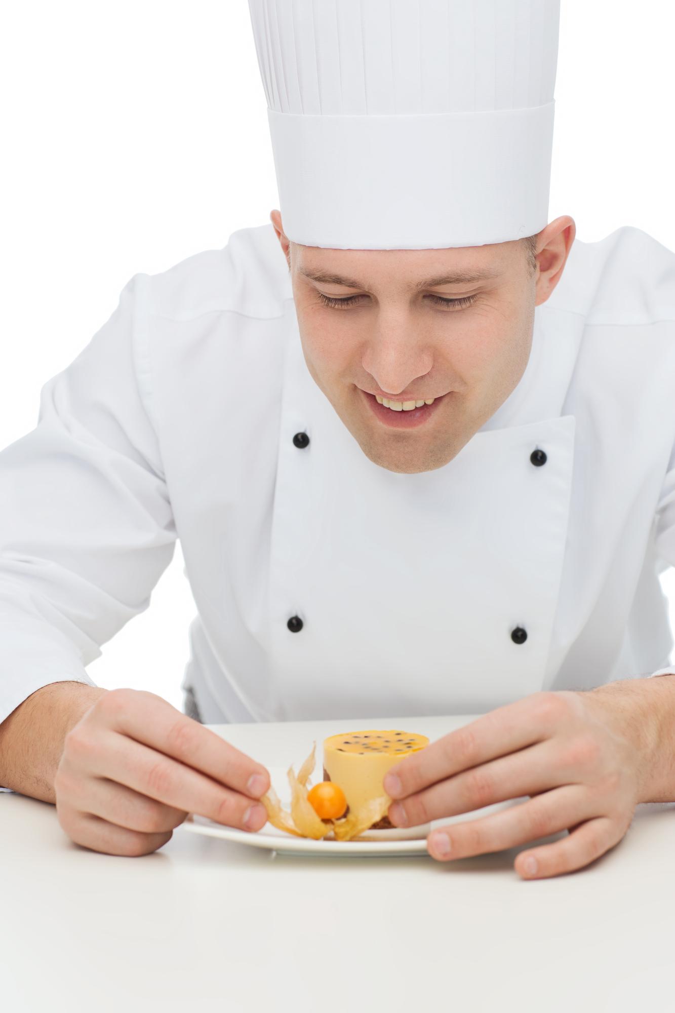 Student garnishing a plated dish
