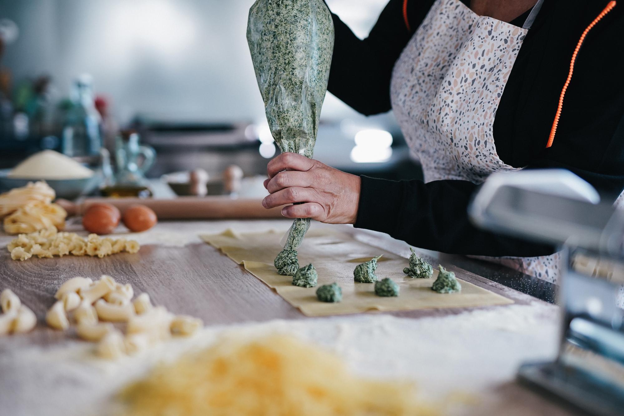 Chef teaching a small class preparing pasta